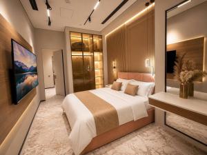 a bedroom with a large bed and a fireplace at AsiaWay Apartment-NEST ONE in Tashkent