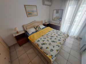 a small bedroom with a bed and a mirror at Villa Lemóni - Villa by the sea with swimming pool and amazing view in Xiropigado +107 photos