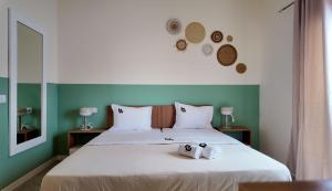 a bed with a stuffed animal on top of it at Urban Hostel Mindelo in Mindelo