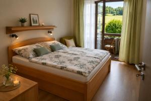 a bedroom with a bed and a window with a view at Apartmán PERLA 28 Říčky v Orlických horách in Říčky