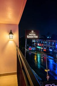 a sign on the side of a building at night at Hotel Sakthi in Kottayam