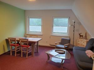 a living room with a table and chairs and a couch at Sauberghaus Wohnung 1 in Breitenbrunn