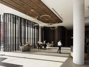 a lobby with people walking around in a building at Novotel Perth Murray Street in Perth +162 photos