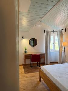 a bedroom with a bed and a desk and a mirror at Laurus Home Restaurant B&B Cilento in Trentinara