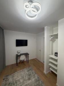 a living room with a table and a chandelier at Ady80 in Balatonmáriafürdő