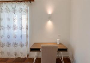 a dining room with a table and a window at Isuleddu Room & Stairs in La Maddalena