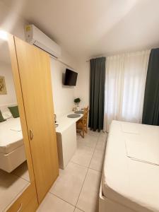 a hotel room with a bed and a desk at Sobe Šušanj in Karlobag