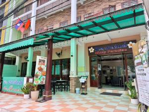 a restaurant with awnings on the side of a building at Mixay Paradise Hotel in Vientiane