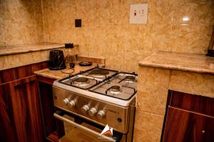 a kitchen with a stove and a counter top at Hols in Kaduna