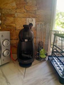 a black coffee maker sitting on a kitchen counter at Romantic house by the River in Pfaffenhoffen