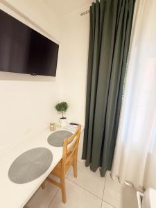 a room with a table and a tv on a wall at Sobe Šušanj in Karlobag