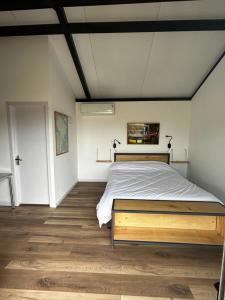 a bedroom with a large bed in a room at Hoxhohl Travel Lodge in Colonia del Sacramento