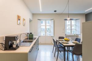 a kitchen and dining room with a table and chairs at Civico Due in Cuneo