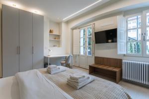 a bedroom with a bed with towels on it at Civico Due in Cuneo