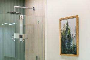 a painting on the wall of a bathroom with a shower at Civico Due in Cuneo +72 photos