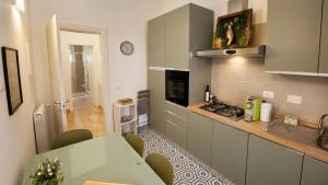 a kitchen with a table and a counter top at Zia Piera in Follonica