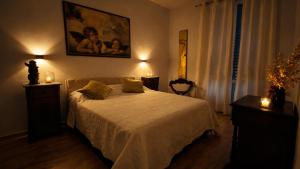 a bedroom with a bed and a painting on the wall at Zia Piera in Follonica