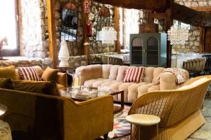 a living room with couches and a table and chairs at Maison Conde de la Cebada in Ampudia