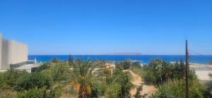 a dirt road with the ocean in the background at Sky Eye Studios in Kokkini Khanion +6 photos