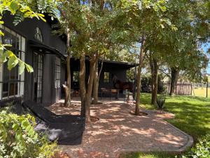 a horse standing in the shade of a building at Field Cabin in Rosendal