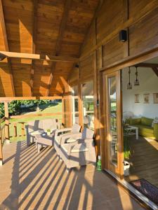a patio with couches and chairs on a deck at LIPA houses & spa in Sopot