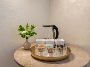 a tray with cups and a tea pot and a vase at Zemlinsky Hof in Payerbach +39 photos