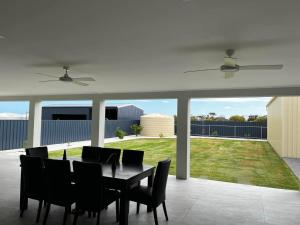 a dining room with a table and some chairs at Moonta Bay Hideaway in Port Moonta