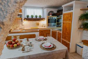 a kitchen with a table with fruit on it at Hiša odprtih vrat in Tolmin