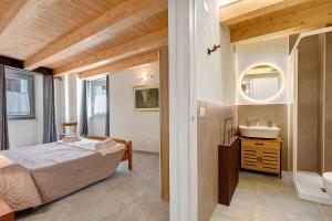 a bedroom with a bed and a sink at Maison Jaccod Apartments in Morgex
