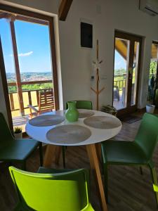 a dining room with a table and green chairs at LIPA houses & spa in Sopot