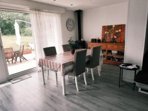 a dining room table and chairs in a room at La Petite Maison dans la Prairie in Cholet