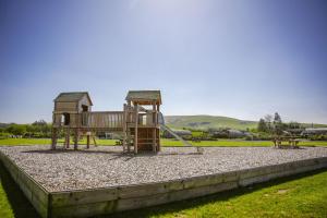 a playground with a slide in a park at Poppy in Rhayader +20 photos