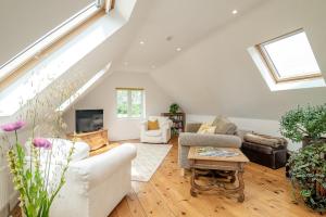 a living room with white furniture and a skylight at 1 Bed in Taunton oc-75135 in Isle Brewers