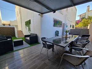 a patio with a table and chairs on a patio at Pool&River Villa in Alcoutim