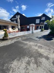 ein Gebäude mit einem weißen Zaun davor in der Unterkunft Hotel-Windeck in Burbach