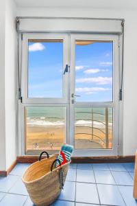 a room with a window with a view of a beach at Numancia 1 - 3A in Las Palmas de Gran Canaria