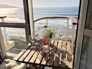 a table on a balcony with a view of the beach at Numancia 1 - 3A in Las Palmas de Gran Canaria
