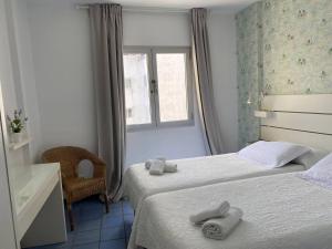 a hotel room with two beds with towels on them at Numancia 1 - 3A in Las Palmas de Gran Canaria