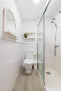 a white bathroom with a toilet and a shower at Numancia 1 - 3A in Las Palmas de Gran Canaria +43 photos