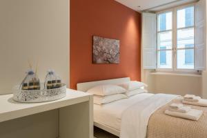 a bedroom with a white bed and a window at Civico Due in Cuneo