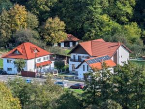 a group of houses with orange roofs on a hill at Mateo Transalpina in Săsciori