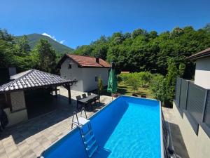 a swimming pool in a yard with a house at Vacation Home Belluna in Račić