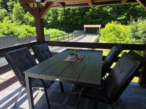 a wooden table and chairs on a patio at Vacation Home Belluna in Račić