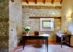 an office with a desk in a stone wall at Tenuta Valdea in Firenzuola