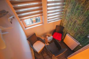 an overhead view of a room with chairs and a table at Residence B&B La Fontaine Aparthotel in Krakow +61 photos