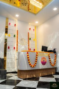 a reception desk in a room with a table with a necklace at Sweekar Executive in Tuljapur