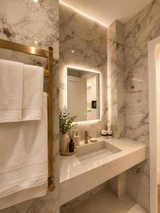 a bathroom with a sink and a mirror at AsiaWay Apartment-NEST ONE in Tashkent +62 photos
