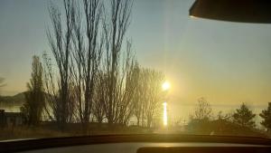 a view of the sunset from a car window at Sunrise and Sunset in Lake Sevan in Sevan