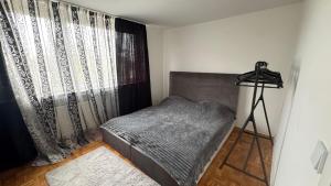 a small bedroom with a bed and a window at Spacious 3-room apartment with balcony in Mönchengladbach