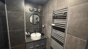 a bathroom with a sink and a mirror at Spacious 3-room apartment with balcony in Mönchengladbach